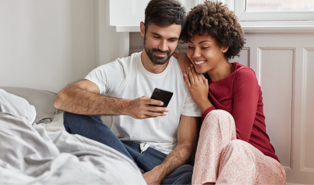 lovely-multiethnic-couple-sit-at-floor-near-bed-e-2023-11-27-05-15-10-utc (1)