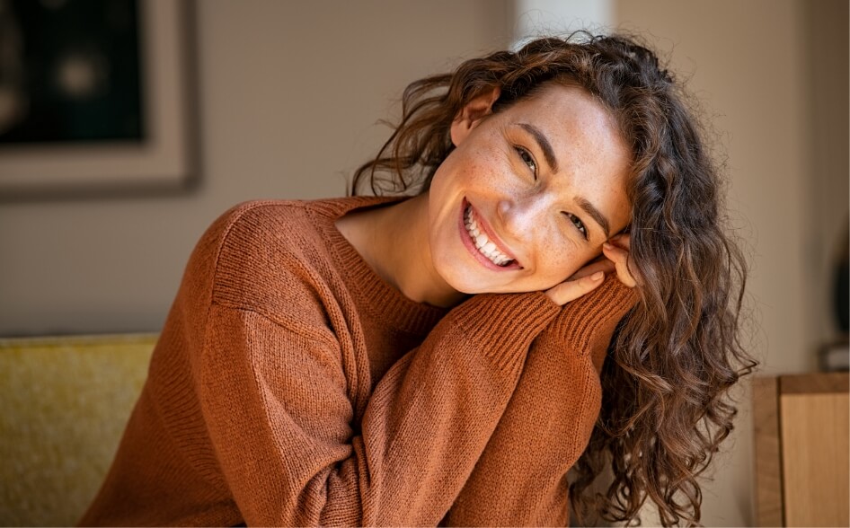 young-woman-laughing-while-relaxing-at-home-2023-11-27-05-26-41-utc (1)